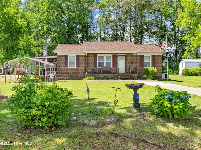 323 Alexander Rouse Rd, Kinston, NC 28504 - single story home with crawl space, a detached carport, a front lawn, brick siding, and covered porch