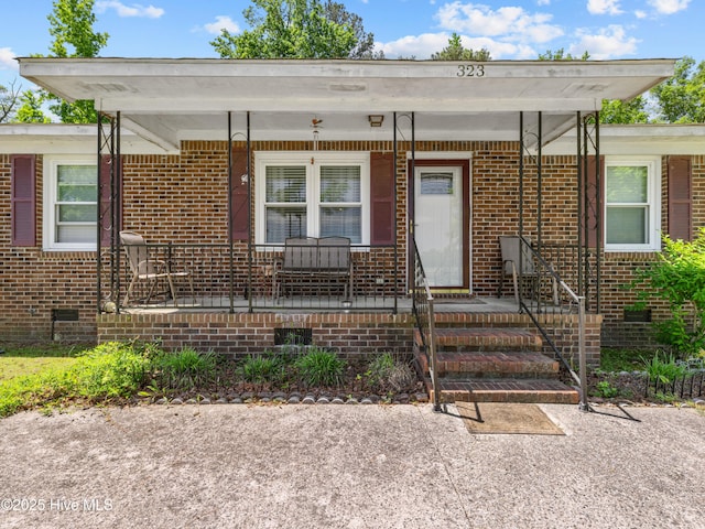 323 Alexander Rouse Rd, Kinston, NC 28504 - view of front of house featuring crawl space, covered porch, and brick siding