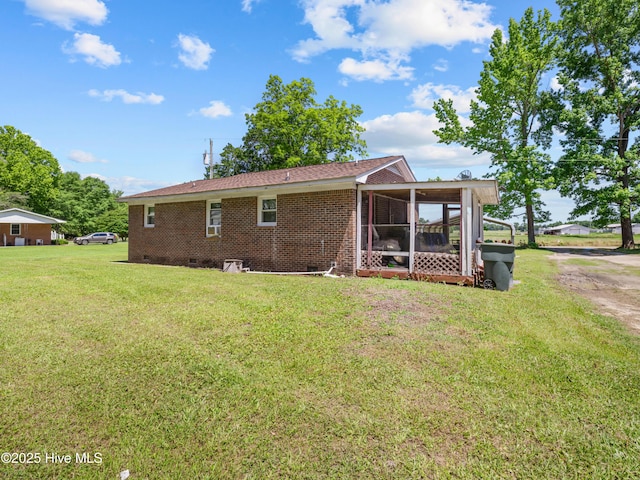 323 Alexander Rouse Rd, Kinston, NC 28504 - rear view of house with crawl space, a sunroom, a yard, and brick siding
