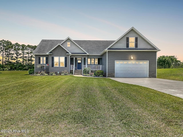 104 Soundside Estates Dr, Grandy, NC 27939 - view of front of house featuring a porch, concrete driveway, a yard, an attached garage, and roof with shingles