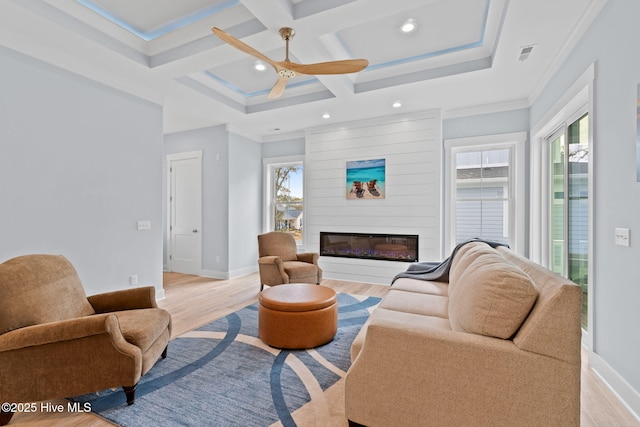 2705 E Oak Island Dr, Oak Island, NC 28465 - living room with healthy amount of natural light, light wood finished floors, ceiling fan, recessed lighting, and a glass covered fireplace