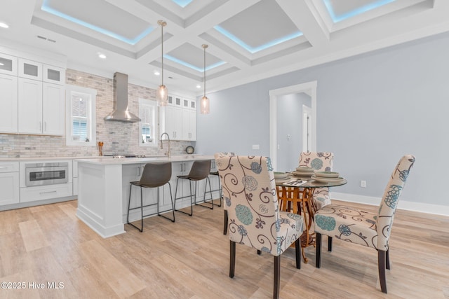 2705 E Oak Island Dr, Oak Island, NC 28465 - dining space with coffered ceiling, light wood-style floors, recessed lighting, and beam ceiling
