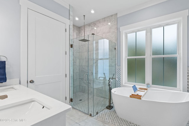 2705 E Oak Island Dr, Oak Island, NC 28465 - bathroom featuring a stall shower, a soaking tub, marble finish flooring, recessed lighting, and double vanity
