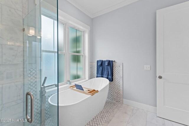 2705 E Oak Island Dr, Oak Island, NC 28465 - bathroom with healthy amount of natural light, marble finish floors, a soaking tub, a stall shower, and crown molding