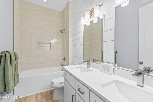2705 E Oak Island Dr, Oak Island, NC 28465 - bathroom with toilet, wood finished floors, double vanity, and shower / bath combination
