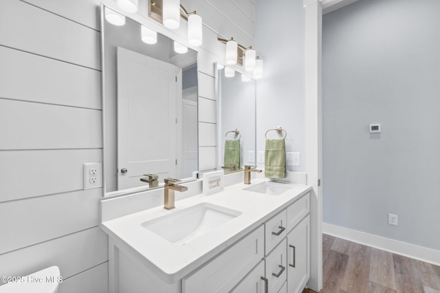 2705 E Oak Island Dr, Oak Island, NC 28465 - bathroom featuring double vanity, wood finished floors, and toilet
