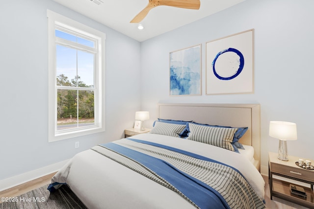 2705 E Oak Island Dr, Oak Island, NC 28465 - bedroom with wood finished floors, baseboards, ceiling fan, and recessed lighting