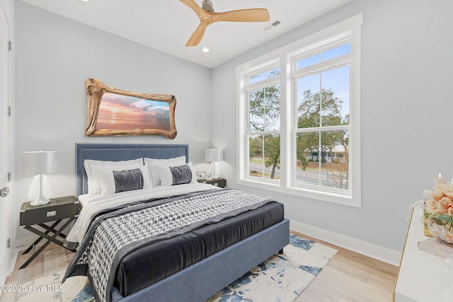 2705 E Oak Island Dr, Oak Island, NC 28465 - bedroom featuring wood finished floors, baseboards, ceiling fan, and recessed lighting
