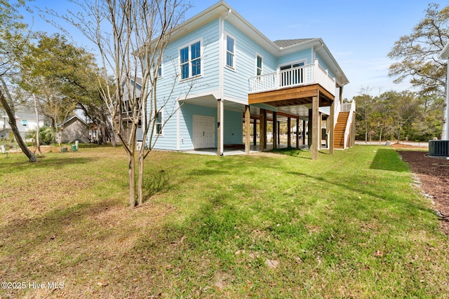 2705 E Oak Island Dr, Oak Island, NC 28465 - back of house featuring stairs, a wooden deck, central AC, and a lawn