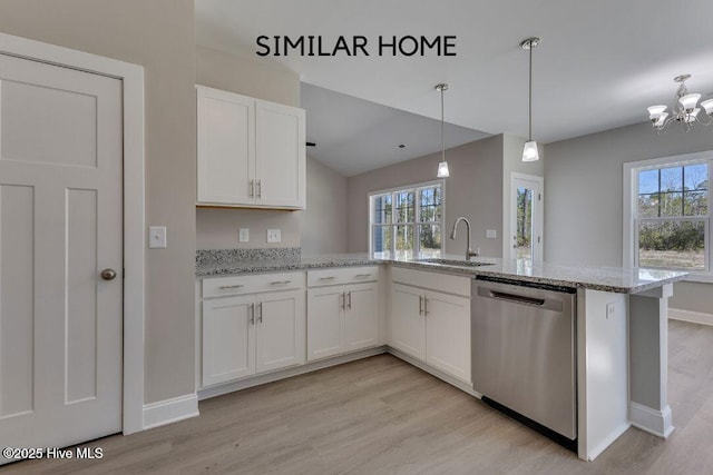 98 NE Dr NW, Calabash, NC 28467 - kitchen with dishwasher, a sink, light wood-type flooring, white cabinetry, and a peninsula