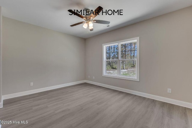 98 NE Dr NW, Calabash, NC 28467 - spare room featuring wood finished floors, a ceiling fan, and baseboards
