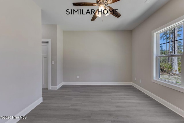 98 NE Dr NW, Calabash, NC 28467 - spare room featuring a ceiling fan, wood finished floors, and baseboards
