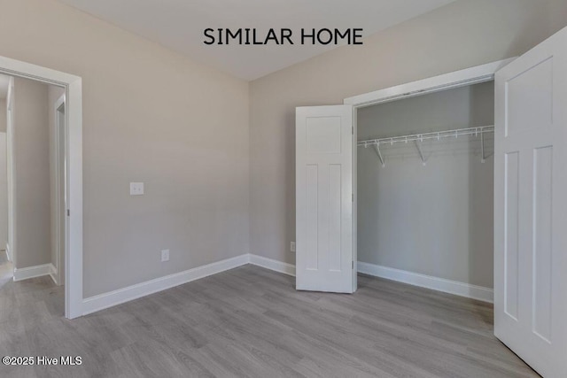 98 NE Dr NW, Calabash, NC 28467 - unfurnished bedroom with a closet, wood finished floors, and baseboards