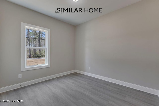 98 NE Dr NW, Calabash, NC 28467 - unfurnished room with dark wood-style flooring and baseboards