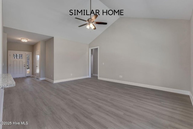 98 NE Dr NW, Calabash, NC 28467 - unfurnished living room featuring ceiling fan, wood finished floors, baseboards, and high vaulted ceiling