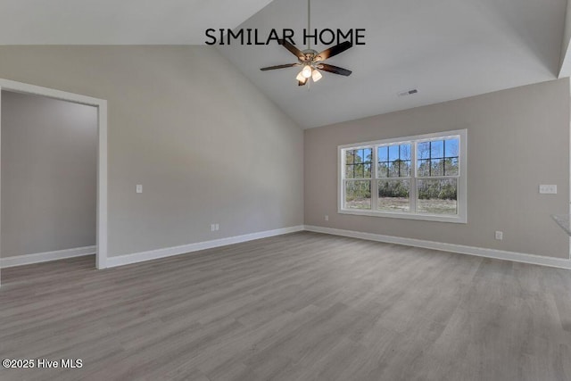 98 NE Dr NW, Calabash, NC 28467 - empty room with ceiling fan, wood finished floors, high vaulted ceiling, and baseboards