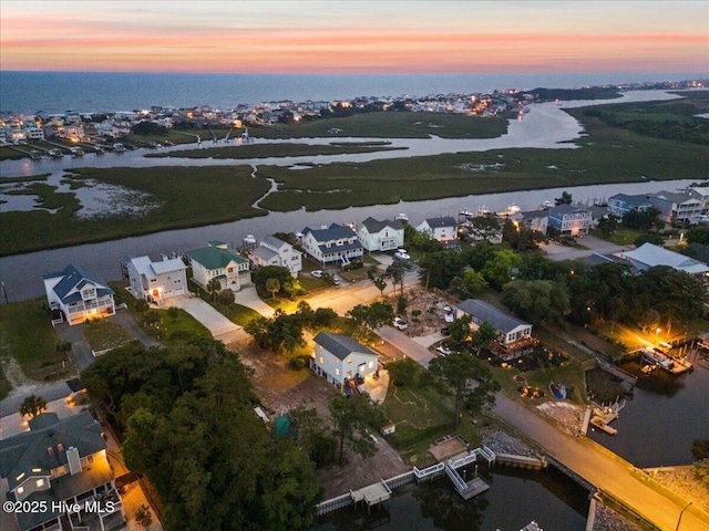 102 E Island Dr, Oak Island, NC 28465 - aerial view of property and surrounding area with a large body of water and nearby suburban area