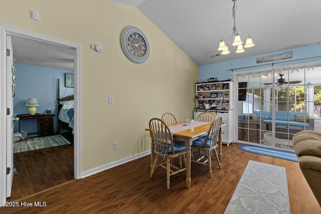 107 Foxlair Dr, Hubert, NC 28539 - dining area featuring a chandelier, lofted ceiling, wood finished floors, and baseboards