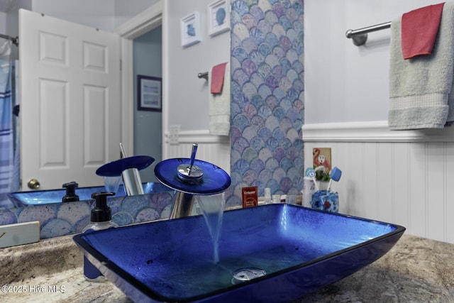 107 Foxlair Dr, Hubert, NC 28539 - bathroom with a decorative wall, a wainscoted wall, and a sink