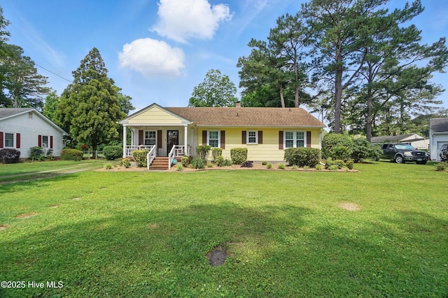 1605 Edgewood Dr, Elizabeth City, NC 27909 - view of front of house with covered porch, a front yard, and a chimney