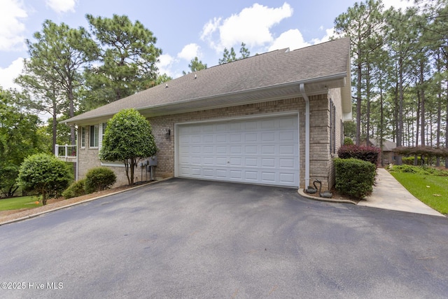 113 Dubose Dr, West End, NC 27376 - view of front facade with driveway, brick siding, and a shingled roof