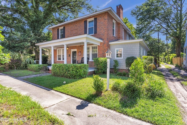 114 N 16th St, Wilmington, NC 28401 - traditional style home with a chimney, a porch, and brick siding