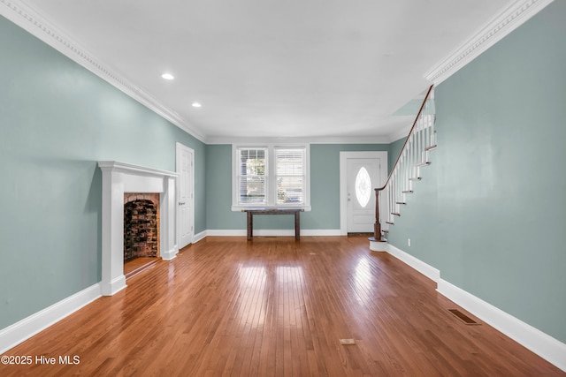 114 N 16th St, Wilmington, NC 28401 - unfurnished living room featuring ornamental molding, a fireplace, wood finished floors, stairs, and recessed lighting