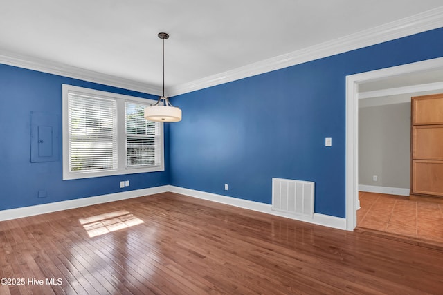 114 N 16th St, Wilmington, NC 28401 - spare room with electric panel, crown molding, and wood finished floors