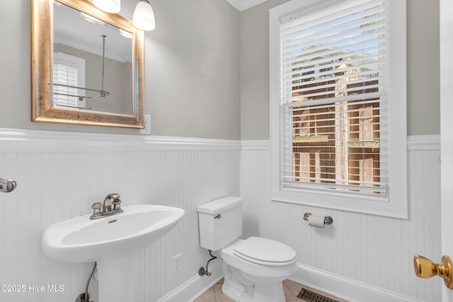 114 N 16th St, Wilmington, NC 28401 - bathroom featuring a wainscoted wall, healthy amount of natural light, and tile patterned floors