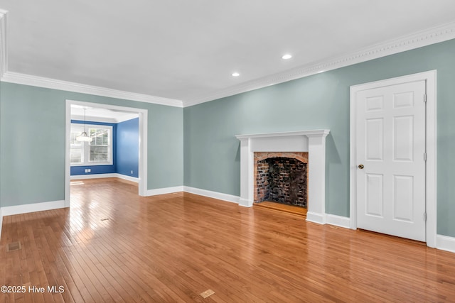 114 N 16th St, Wilmington, NC 28401 - unfurnished living room featuring light wood-style flooring, a fireplace, crown molding, and recessed lighting
