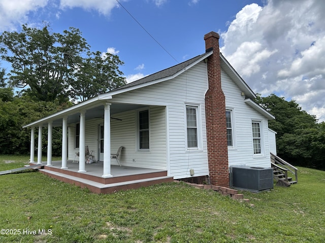 106 W Barrett St, Carthage, NC 28327 - rear view of property with central AC unit, a porch, a chimney, and a yard