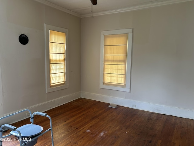 106 W Barrett St, Carthage, NC 28327 - spare room with baseboards, dark wood finished floors, crown molding, and plenty of natural light