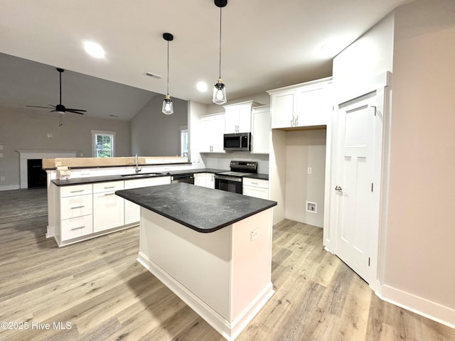 108 Woodford Ln, Vass, NC 28394 - kitchen featuring appliances with stainless steel finishes, a sink, a peninsula, ceiling fan, and dark countertops