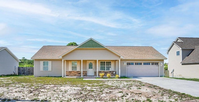 213 Lockwood Ct, Hubert, NC 28539 - view of front facade with a garage, covered porch, and concrete driveway