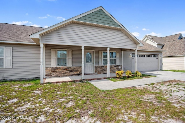 213 Lockwood Ct, Hubert, NC 28539 - view of front facade featuring a garage, a porch, driveway, and a shingled roof