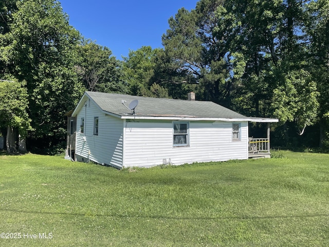 512 Walton Ln, Tyner, NC 27980 - view of home's exterior with a lawn, a chimney, and view of scattered trees