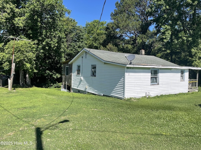 512 Walton Ln, Tyner, NC 27980 - view of home's exterior with a yard, a chimney, and view of wooded area
