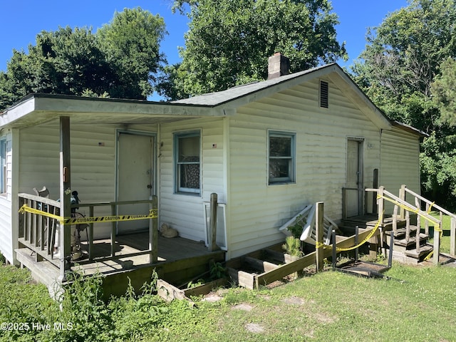 512 Walton Ln, Tyner, NC 27980 - rear view of house with a chimney, a lawn, and a wooden deck