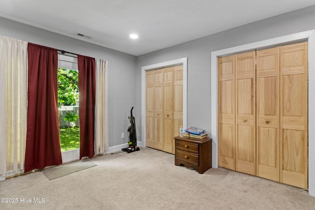 406 Walnut St, Elizabeth City, NC 27909 - bedroom with multiple closets, light colored carpet, recessed lighting, and baseboards