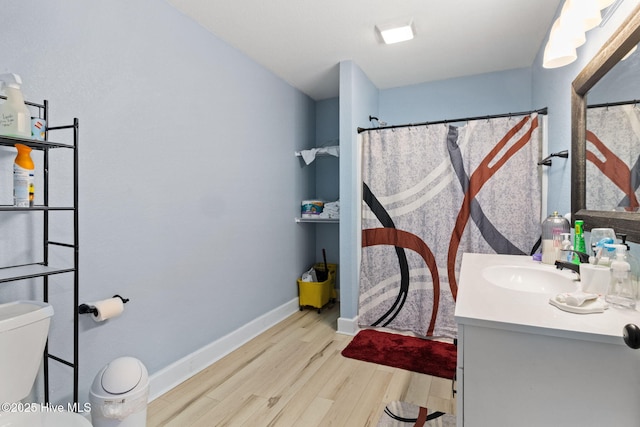 406 Walnut St, Elizabeth City, NC 27909 - full bathroom featuring wood finished floors, vanity, toilet, baseboards, and curtained shower