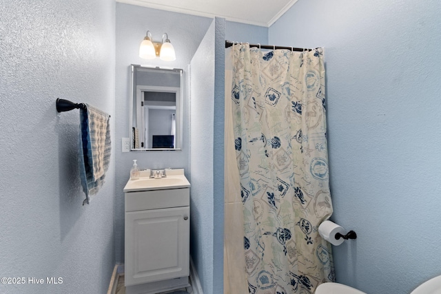 406 Walnut St, Elizabeth City, NC 27909 - bathroom with vanity, toilet, crown molding, a textured wall, and a shower with shower curtain