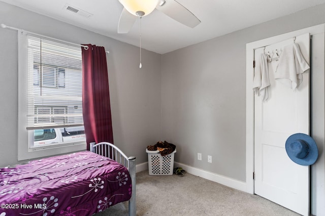 406 Walnut St, Elizabeth City, NC 27909 - carpeted bedroom featuring multiple windows, baseboards, and ceiling fan