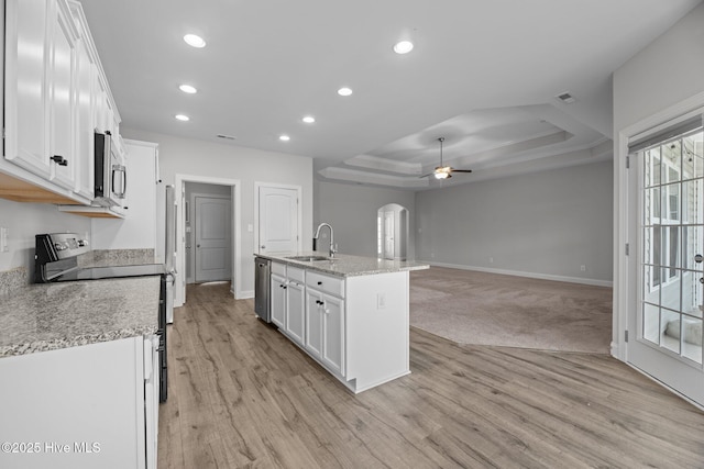2001 Snapper St, New Bern, NC 28562 - kitchen featuring a sink, a raised ceiling, stainless steel appliances, ceiling fan, and white cabinetry