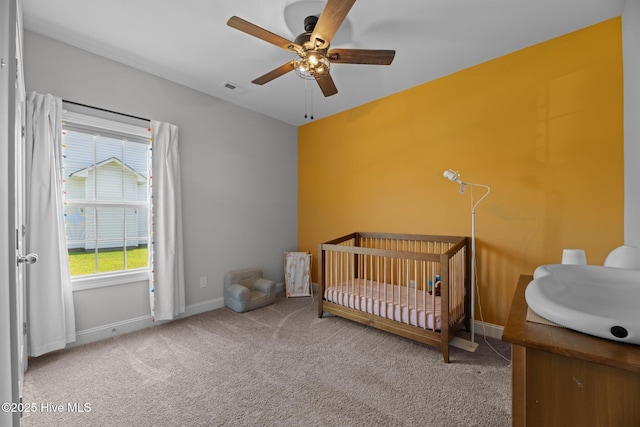 2001 Snapper St, New Bern, NC 28562 - carpeted bedroom featuring a sink, a nursery area, baseboards, and ceiling fan