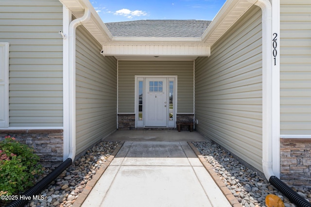 2001 Snapper St, New Bern, NC 28562 - view of exterior entry featuring stone siding and roof with shingles