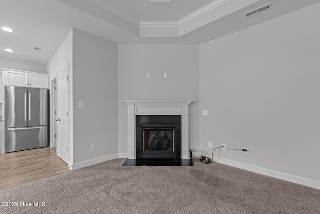 2001 Snapper St, New Bern, NC 28562 - unfurnished living room with recessed lighting, crown molding, baseboards, a fireplace with flush hearth, and carpet floors
