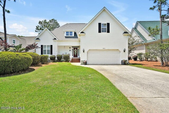 3212 Wexford Way, Southport, NC 28461 - traditional home with a garage, concrete driveway, and a front lawn