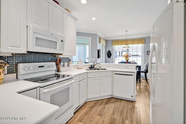 3212 Wexford Way, Southport, NC 28461 - kitchen featuring white appliances, light wood finished floors, recessed lighting, a peninsula, and white cabinetry