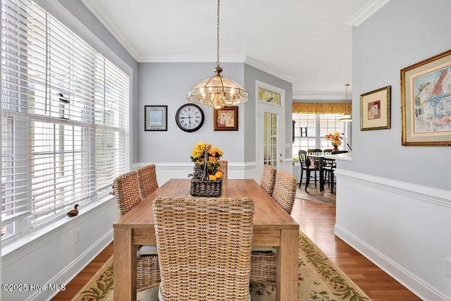 3212 Wexford Way, Southport, NC 28461 - dining area with a chandelier, wood finished floors, and ornamental molding