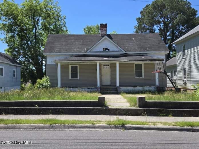 714 Leak St, Rockingham, NC 28379 - view of front of property featuring covered porch and a chimney